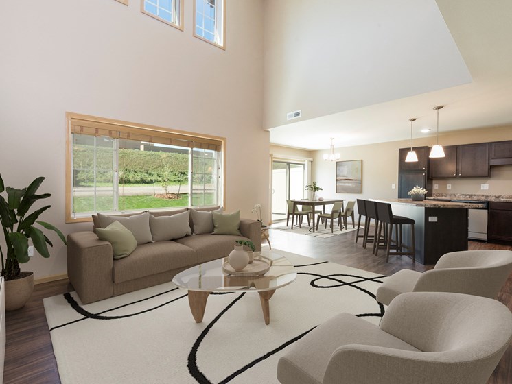 Bismarck, ND Stonefield Townhomes. The large room showcases comfortable seating, modern decor, and natural lighting, creating a welcoming and relaxing space for residents.